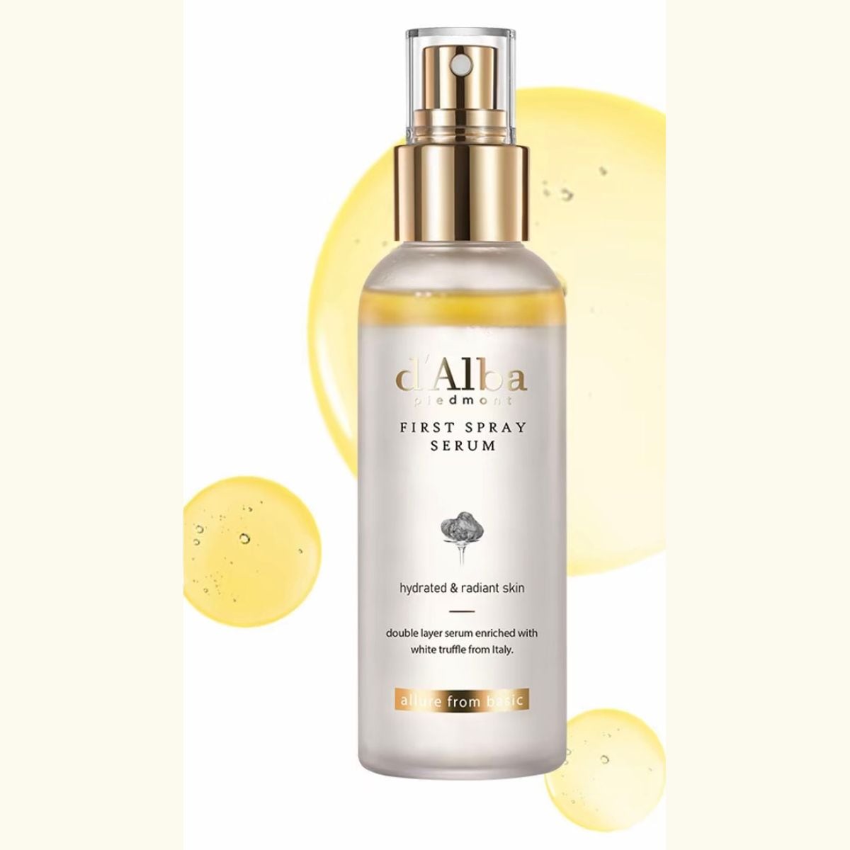 d'Alba White Truffle First Spray Serum bottle with a gold spray cap, shown with drops of golden oil
