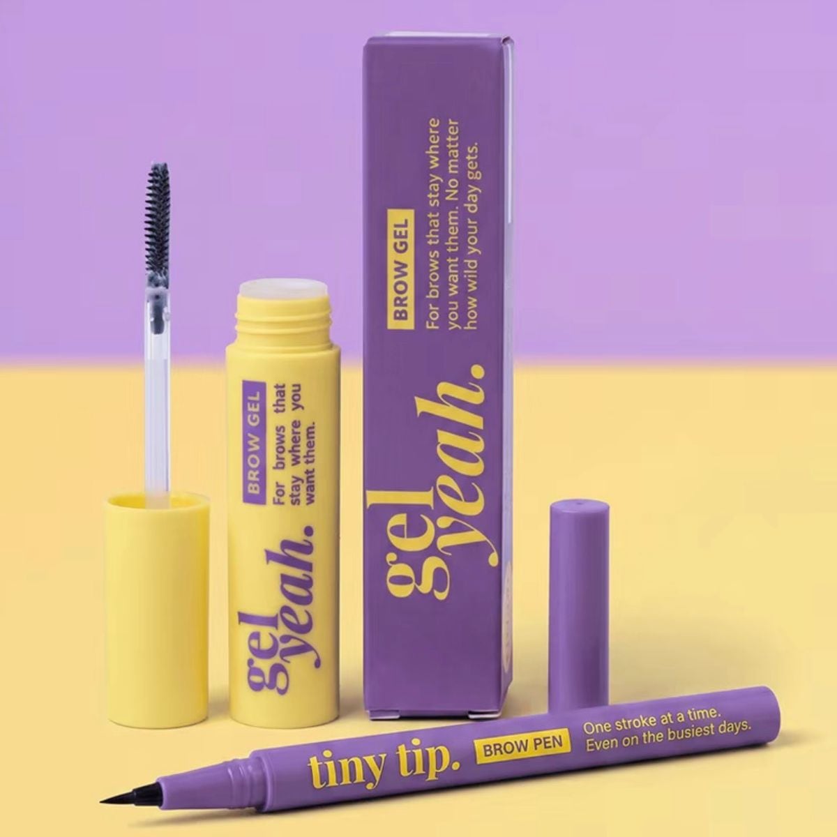 GirlGotLashes Gel Yeah brow gel with open brush and purple box, next to the purple Tiny Tip brow pen, on a lilac and yellow background