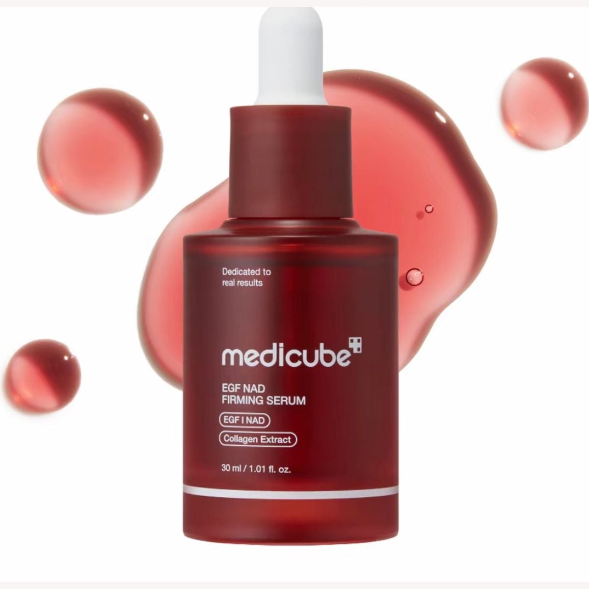 medicube EGF NAD Firming Serum 30 ml, a dark red dropper bottle with a white bulb, with drops of rosy-red serum around it
